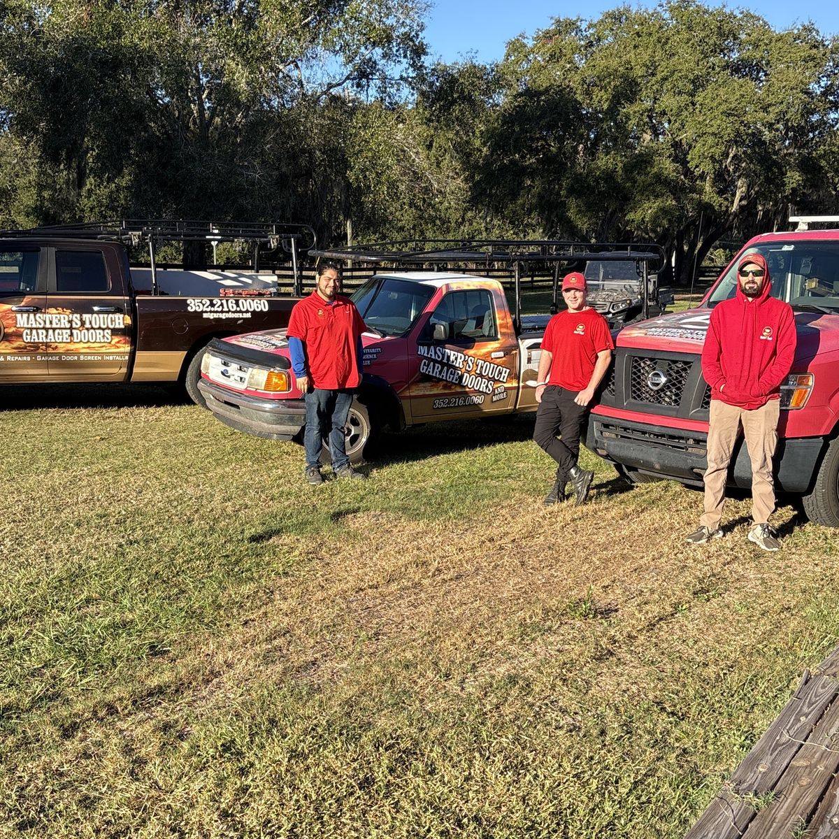 The Master's Touch crew standing in front of their three branded service trucks
