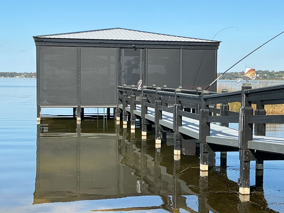 A dock house on a Central Florida lake fully enclosed in motorized screens
